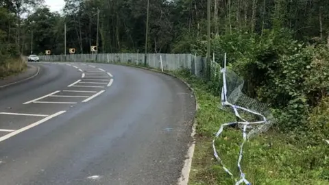 Damaged fencing and police tape