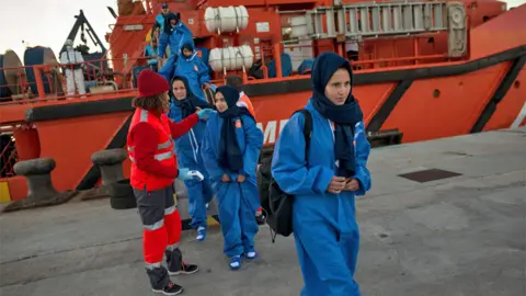 Getty Images Refugees arriving in Spain