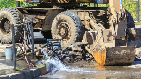 Getty Images Fixing a broken pipe