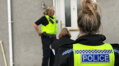 North Tyneside Council Police officers outside house