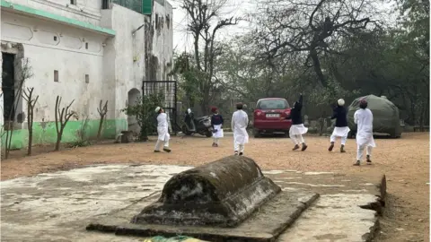 Children play cricket