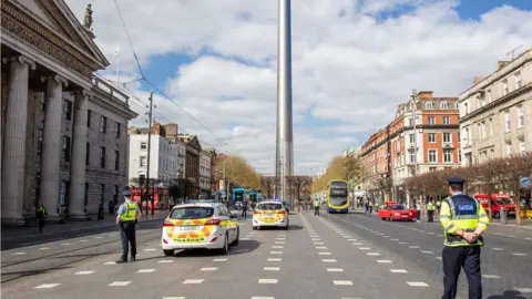 PAUL FAITH/Getty Images Irish police on O'Connell Street, Dublin