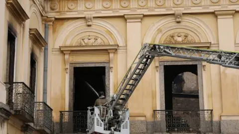 Reuters A firefighter sprays water at the National Museum of Brazil in Rio de Janeiro on 3 September 2018.