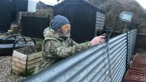 BBC Lance Martin in his garden overlooking the sea