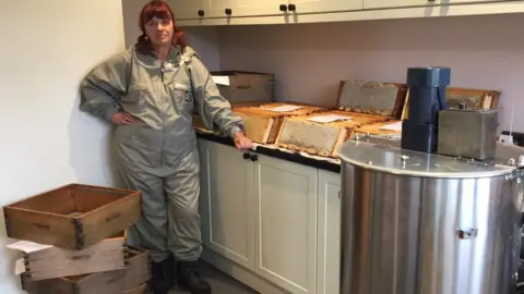 Joyce Wells Joyce Wells extracting honey