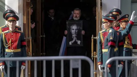 EPA Dmitry Muratov carries portrait of Mr Gorbachev as he leads the coffin out after the lying in state