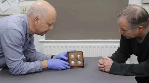 Manx National Heritage Manx National Heritage Conservator Chris Weeks (left) and Matthew Richardson (right) examine the portraits