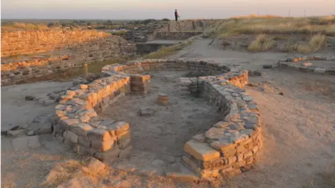 AFP A tourist explores the ancient Dholavira archelogical site in Kachchh district in Gujarat state on December 18, 2011. Dholavira has emerged as a major Harappan city remarkable for its exquisite town planning, monumental structures, aesthetic architecture and amazing water management and storage system. Dholavira excavated site is maintained by the Archaeological Survey of India