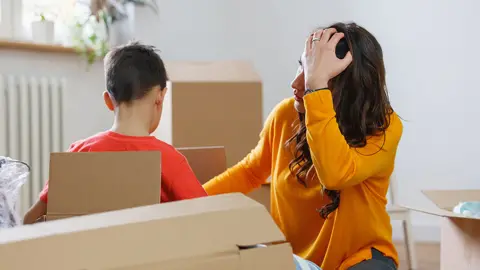 Getty Images Woman packing moving boxes