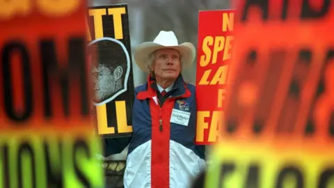 Getty Images Rev Fred Phelps and his flock protest in Laramie in April 1999