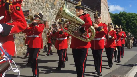 BBC The band at the front of the RGLI parade sets off