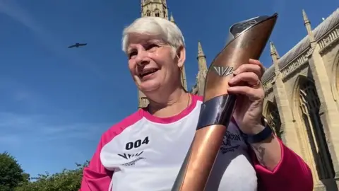 Linda Baxter holding torch