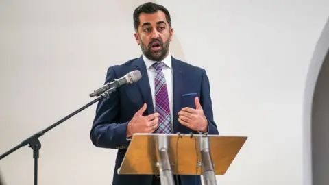 PA Media First Minister Humza Yousaf speaks during an anti-poverty summit