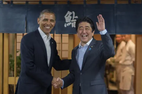 AFP/Getty Images US President Barack Obama (L) shakes hands with Japanese Prime Minister Shinzo Abe before a private dinner at Sukiyabashi Jiro restaurant in Tokyo on 23 April 2014.