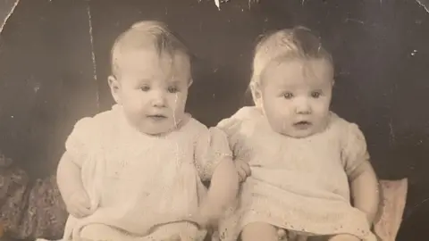 Wright family Two young girls wearing identical outfits