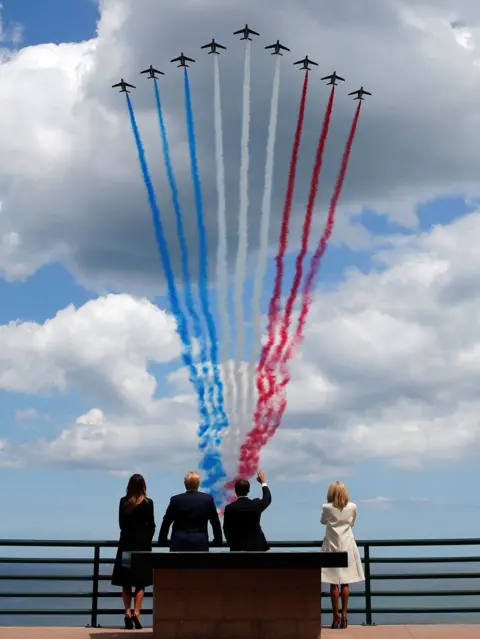 Press Eye President Trump First Lady Melania Trump, French President Emmanuel Macron and his wife Brigitte Macron watch a flypast in the Normandy American Cemetery