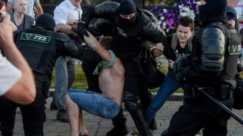 EPA Riot police detain a protester in Minsk, Belarus. Photo: 10 August 2020