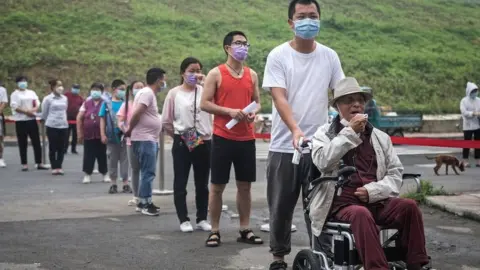 Getty Images Wuhan residents line up for testing