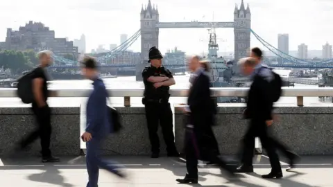 Reuters Police and commuters on bridge