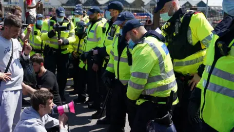 PA Media Protesters sit in road