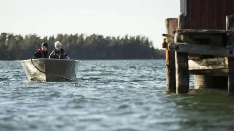 Visit Finland Two people boating on one of Finland's 187,888 lakes