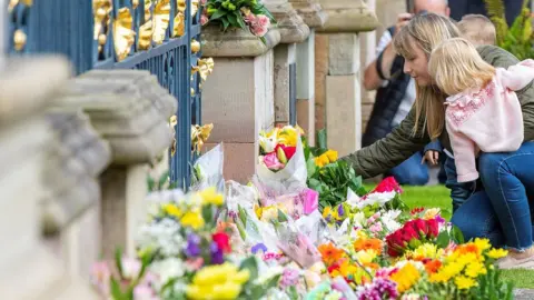 Paul Faith/Getty Floral tributes at Hillsborough Castle