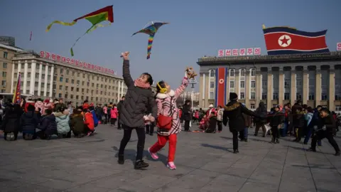 Getty Images Children fly kites during Lunar New Year festivities on Kim Il Sung square in Pyongyang on February 16, 2018