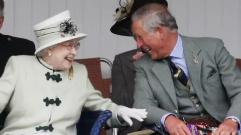 PA Media Queen Elizabeth II and King Charles III at the Braemar Highland Games in 2010