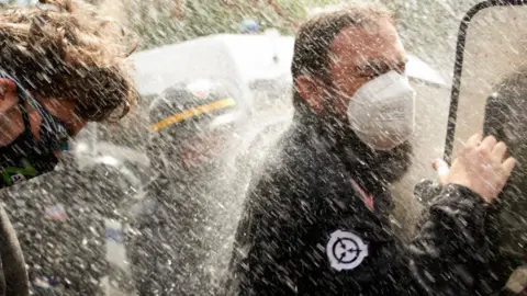 Getty Images Protesters sprayed with water cannon in Toulouse