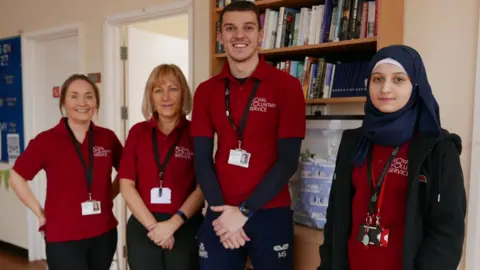 Royal Voluntary Service Four people in Royal Voluntary Service uniforms