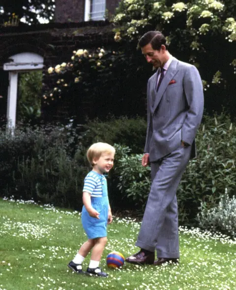 PA Prince of Wales and Prince William playing in the garden of Kensington Palace, London.