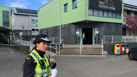 BBC Police officer outside of school
