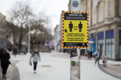 Getty Images A sign with Covid restrictions in Cardiff's city centre during lcokdown