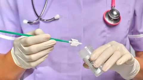 Getty Images Nurse holds cervical screening brush