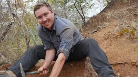 Stephen Tolan/Virginia Tech Christopher Griffin in 2017, excavating part of the Mbiresaurus raathi skeleton