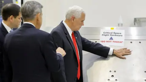 Reuters US Vice-President Mike Pence touches a piece of hardware with a warning label "Do Not Touch" at the Kennedy Space Centre, 6 July 2017
