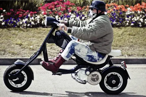 Getty Images A skinhead rides his 'Skelly' style Lambretta along Ryde Seafront. Isle Of Wight Scooter Rally 2011