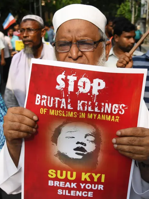 Getty Images An Indian Muslim activist holds a placard calling on Aung San Suu Kyi to stop the killing of the Rohingya, pictured in a protest in Kolkata on 7 September 2017.