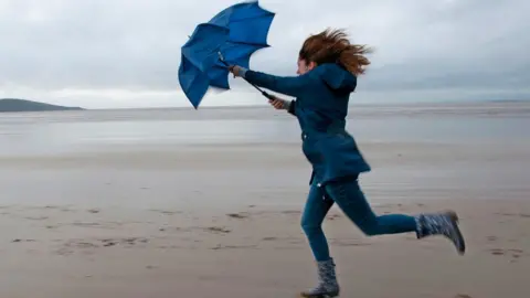 Getty Images Woman holding umbrella