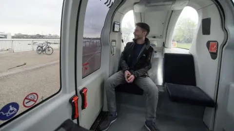 PA Media Man in driverless pod