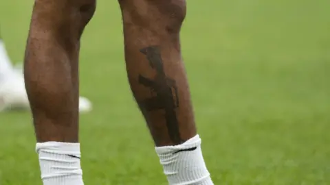 Getty Images Sterling's tattoo was pictured during training in Burton-on-Trent on Bank Holiday Monday