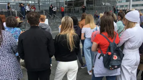 Students listening to speeches from Plaid Cymru leader Adam Price at the Senedd steps