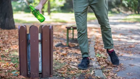 Getty Images Man picking up litter