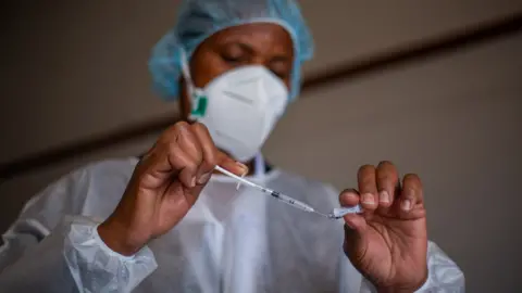 A nurse prepares to vaccinate locals with Sputnik V vaccine at a local clinic on July 9, 2021 in Harare, Zimbabwe.