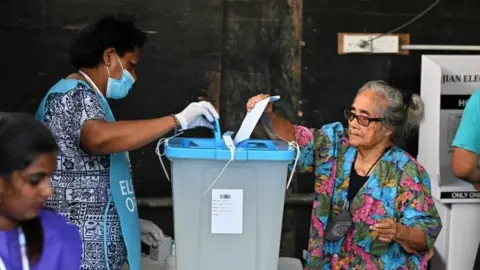 Reuters People vote at a polling station in Suva, Fiji. Photo: 14 December 2022