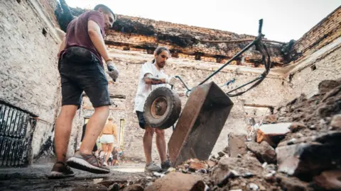 Repair Together Rubble and dust being cleared