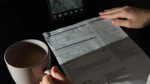 PA Media Person looking at energy bills amid cost of living crisis