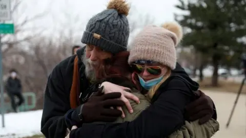 Reuters Sarah Moonshadow is comforted by David and Maggie Prowell after Moonshadow was inside King Soopers grocery store during a shooting in Boulder, Colorado, on 22 March 2021.