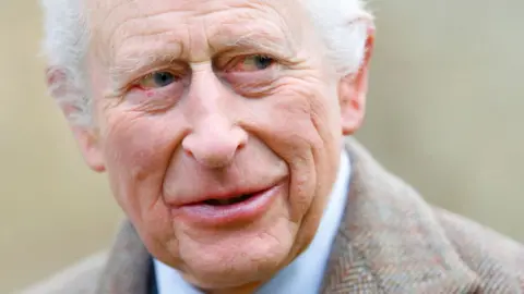 Getty Images King Charles wears a sandy-coloured overcoat and white shirt while attending a service at the Church of St Mary the Virgin, close to the Sandringham Estate in Norfolk, England, on 26 January, 2025.