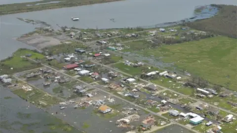 Reuters Flood waters surround buildings as seen from a U.S. Coast Guard overflight to survey post Hurricane Laura damage in Lake Charles, Louisiana, U.S. August 27, 2020.